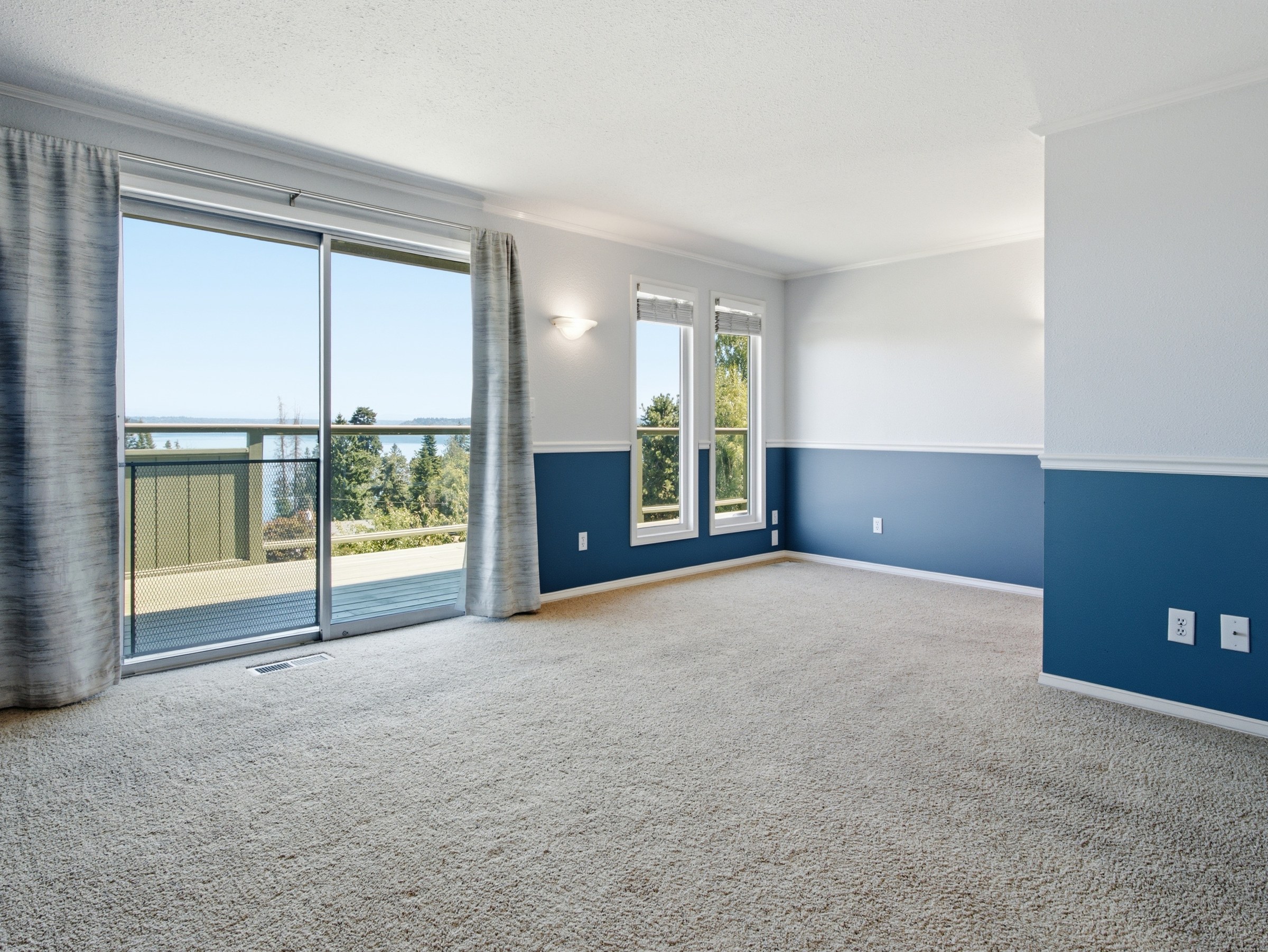 Primary bedroom with water view and natural light in Port Orchard