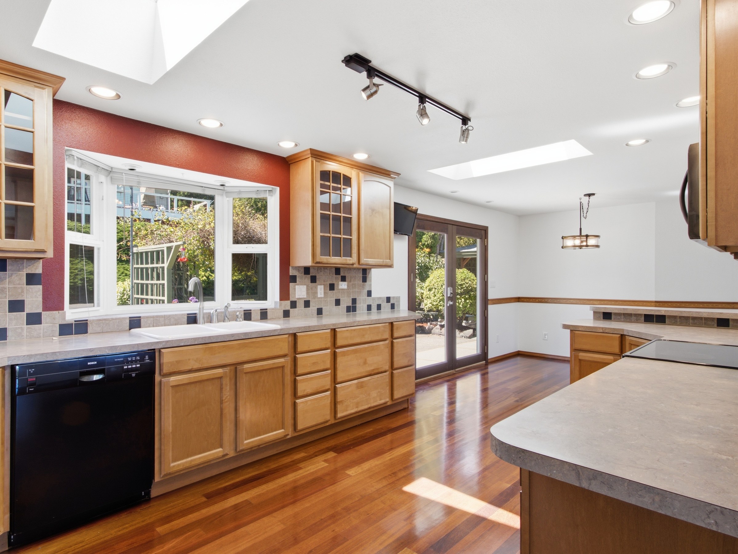 Straight-on kitchen composition featuring the sink window and garden view